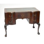 A 1920s mahogany writing desk with green leather inset top above an arrangement of five drawers,