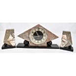 An Art Deco rouge marble clock garniture of angular form, the circular dial set with Arabic