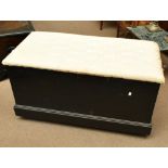 A stained pine twin handled chest with cream upholstered hinged seat on castors, height 53cm, length