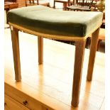 A limed oak Elizabeth II Coronation stool with green padded dished seat and square sectioned legs.