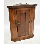 A late 18th/early 19th century corner cupboard with single door enclosing two shelves, approx 82 x