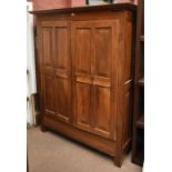 A large French 19th century walnut wardrobe with moulded dentil cornice above twin panelled doors,