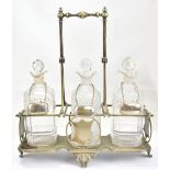 A late 19th century electroplated three division decanter stand housing three clear glass decanters,