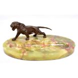 An Art Deco green onyx and cold painted bronze mounted oval dish with lioness above dished well,