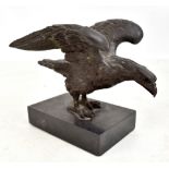 A well modelled patinated bronze eagle mounted on rectangular black hardstone base, apparently