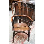 A 19th century yew framed and elm seated Windsor chair with pierced and carved splats on turned