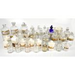 Fifteen assorted glass pharmacy bottles including a large example with original glass labels