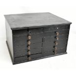 An early 20th century black painted miniature twelve drawer chest with moulded rectangular top above