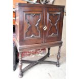 An 18th century oak cabinet with twin fielded doors enclosing arrangement of two short and three