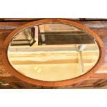An Edwardian mahogany and line inlaid oval wall mirror with bevelled plate, 69 x 49cm.Additional