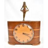 A rare Art Deco combination money box and clock with bronzed figural finial, the circular dial set