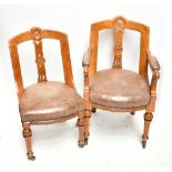 A set of eight late Victorian walnut dining chairs with carved shell and foliate detail, studded