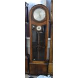 An early 20th century oak cased longcase clock, with arched top, the silvered dial set with Arabic