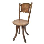 IN THE MANNER OF WILLIAM BIRCH; an elm seated office chair with carved back and swivel seat on