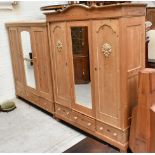 Two modern pine triple door wardrobes, one with carved foliate detail, height 213cm, width 165cm (