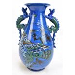 CH BRANNAM; a twin handled art pottery vase with tubeline decoration of mythical birds, with applied