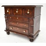 A Victorian mahogany miniature chest of drawers, with four central drawers with ivory handles,