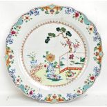 A late 18th/early 19th century Chinese Export charger with shaped rim, typical interior scene to