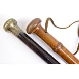 Two late 19th/early 20th century walking sticks, one with hallmarked silver handle and ebonised