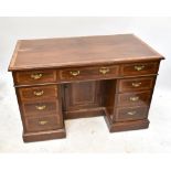 An Edwardian inlaid mahogany knee-hole desk with an arrangement of nine drawers surrounding a set of