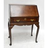 A reproduction oak bureau, the fall-front enclosing fitted interior above a single base drawer,
