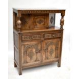 A reproduction carved oak court cupboard with two drawers over two panelled cupboard doors, height