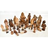 A collection of 19th century and later Black Forest and other carved wooden figurines and bottle