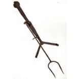 A 19th century wrought iron toaster or griller with twin pronged fork, length 62cm.Additional