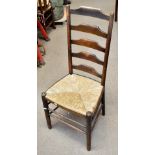 A set of four beech and elm ladder back side chairs with rush seats on stretchered supports (4).