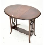 An Edwardian mahogany and inlaid oval swivel-top Sutherland table with pierced heart detail and