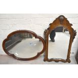 A walnut framed fretwork wall mirror with carved detail, 76 x 45cm, and a lobed mahogany example (
