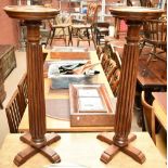 A pair of mahogany jardinière stands, raised on fluted column supports, height 96cm, diameter at the