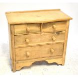 An early 20th century stripped pine serpentine fronted chest of two short above two long drawers,