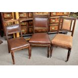 A harlequin set of fifteen early 20th century oak framed dining chairs with leatherette studded