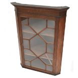 A 19th century oak corner cupboard with astragal glazed door enclosing two shelves, 98 x 71 x 44cm.