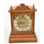 WINTERHALDER & HOFMEIER; a circa 1900 German walnut mantel clock with carved detail, the silvered