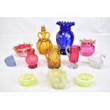 A collection of Victorian and later glassware to include cranberry glass vases, bowls, vaseline