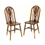 A set of four reproduction oak wheel back dining chairs (4).