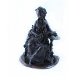 A bronze figure of a seated young woman reading a book of music, height 36cm.