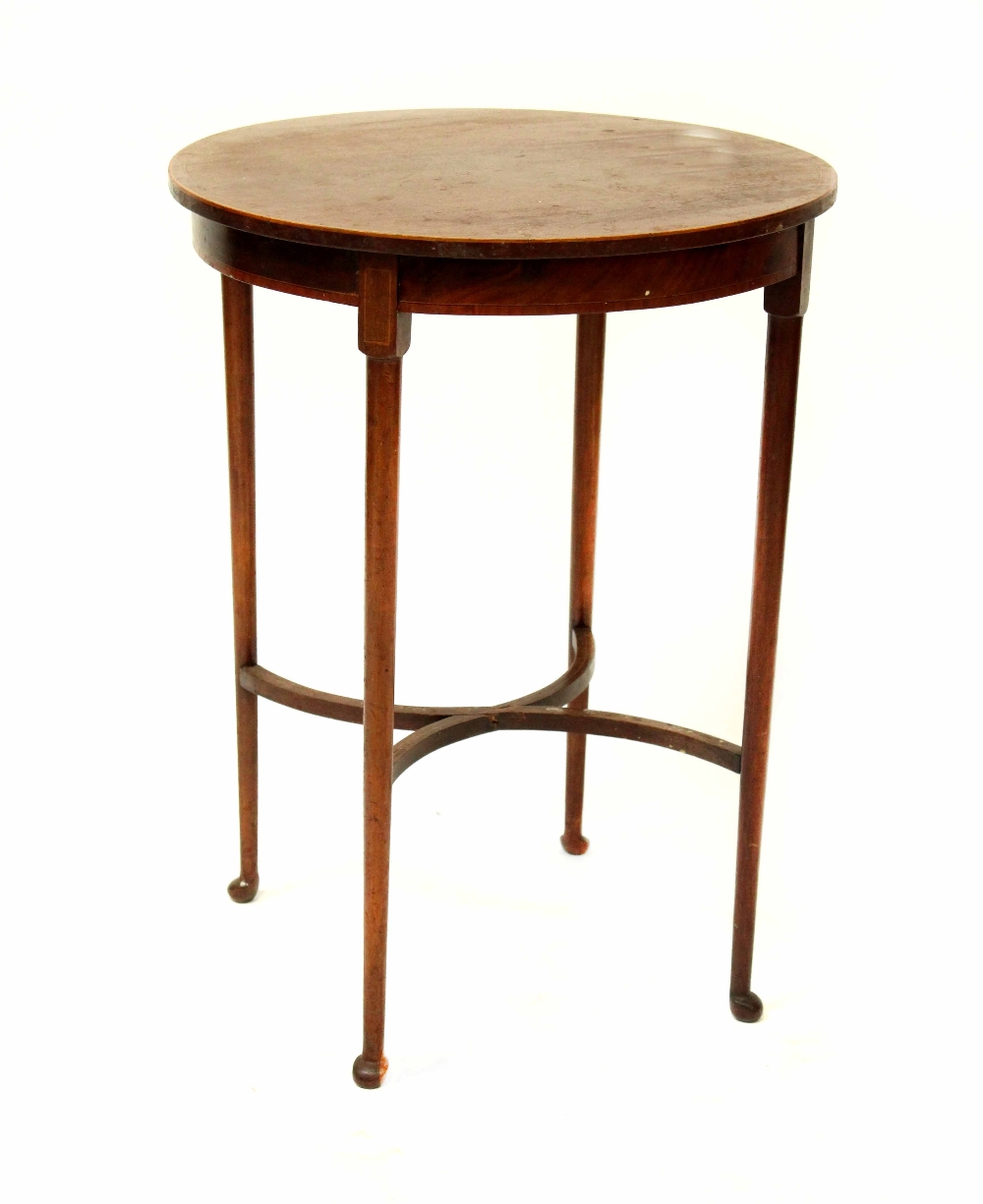 An Edwardian mahogany inlaid circular occasional table raised on tapering supports united by an