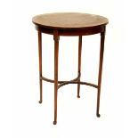 An Edwardian mahogany inlaid circular occasional table raised on tapering supports united by an