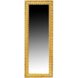 A gilt-framed rectangular wall mirror with bevelled plate, 137 x 49cm.