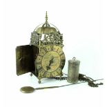 An early 20th century brass lantern clock, by Thos. Moore, Ipswich, with weight and pendulum.