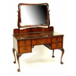 A 19th century style mahogany dressing table with swing mirror, on base with five drawers,