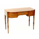 A mahogany kneehole writing table with bowed central section, three frieze drawers,