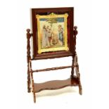 An Edwardian mahogany swing easel, the top enclosing a tapestried picture in a gilt frame,