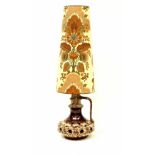 A West German pottery double bulb table lamp with pierced design and tall conical floral decorated