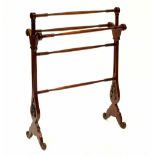 An Edwardian-style stained wood towel rail with pierced decoration, on outswept legs, width 73cm,