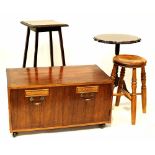 A two-door record cabinet raised on castors, an oak square-topped occasional table,