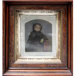 A negative print of an older lady wearing a bonnet within a mahogany decorative frame,